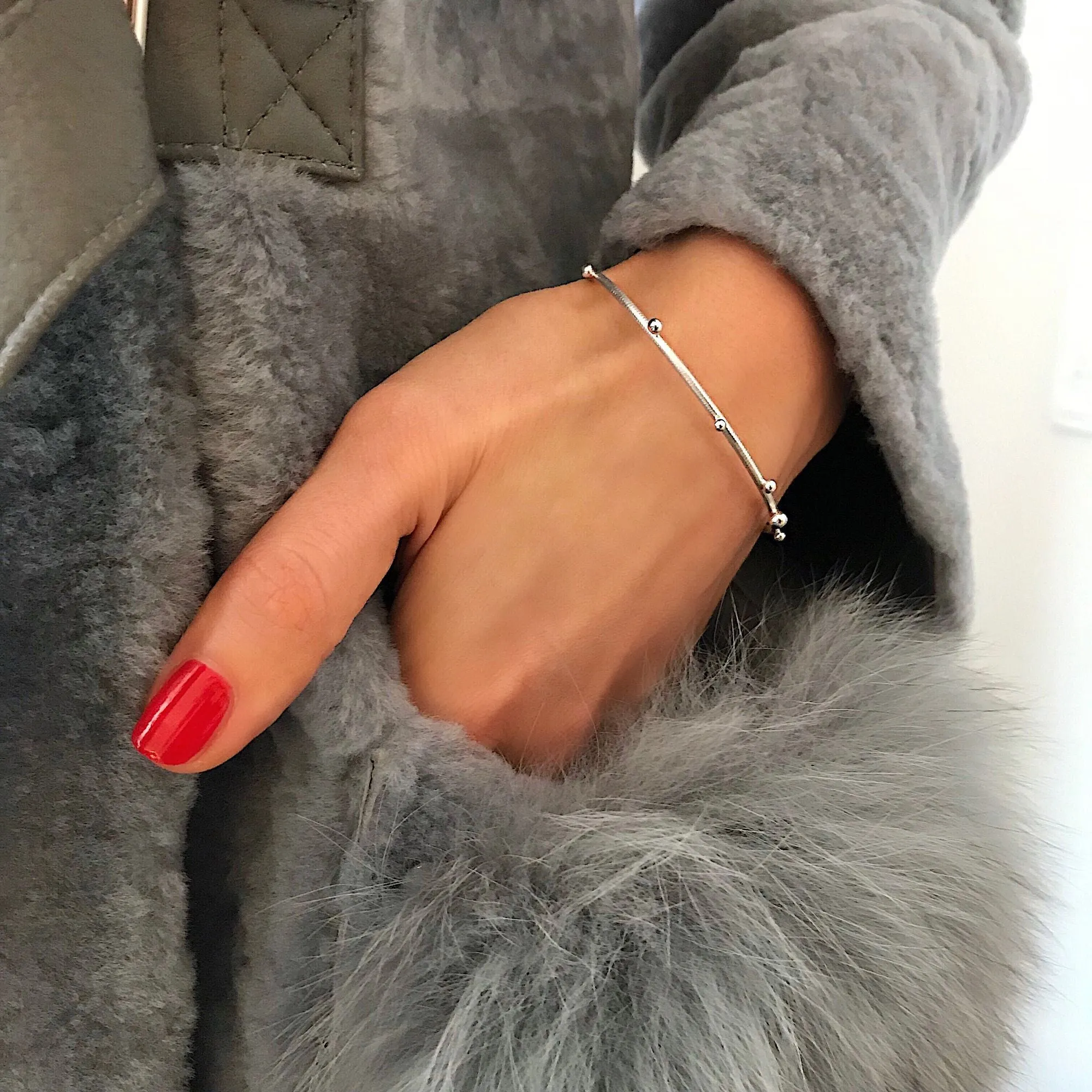 Delphis Silver Bangle