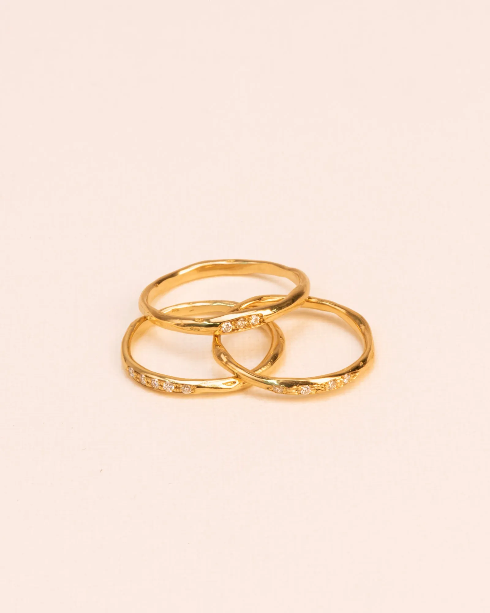 Set of three stacked organic 18K Gold Rings w. Diamonds
